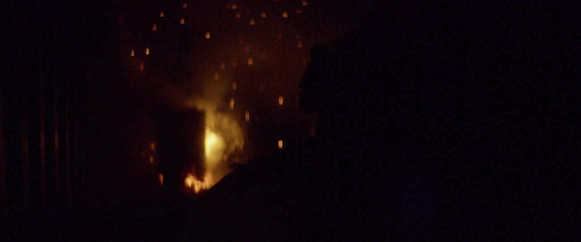 A firefighter is spraying water on a flame