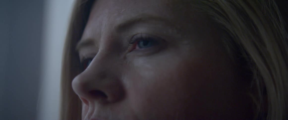 A woman looks out the window
