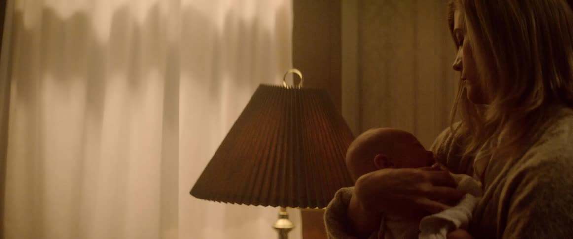 A mother gently rocking her baby