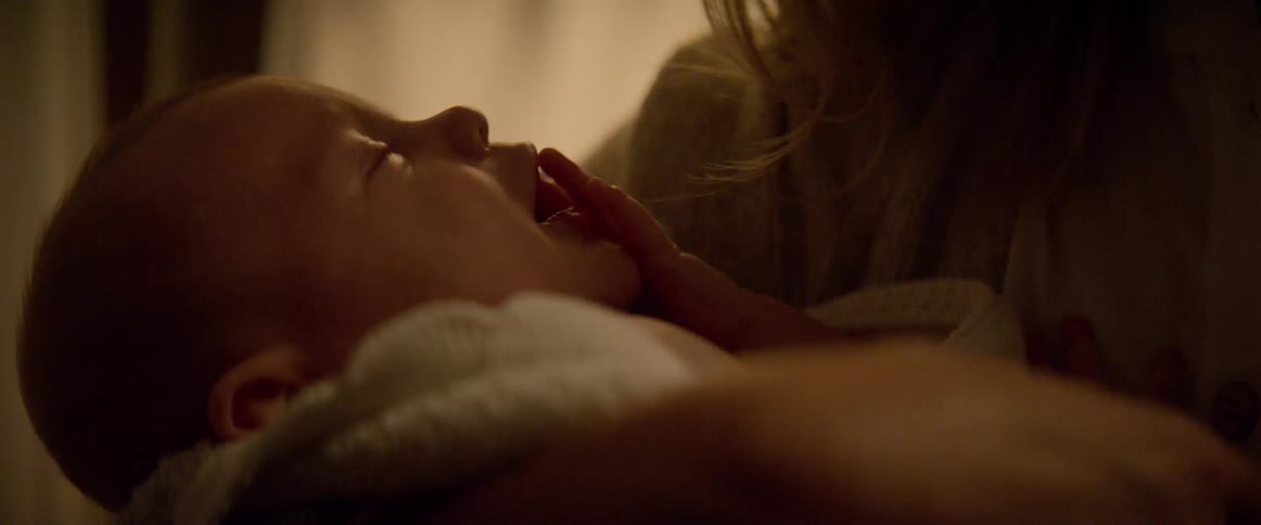 Mother rocking her crying baby to comfort her