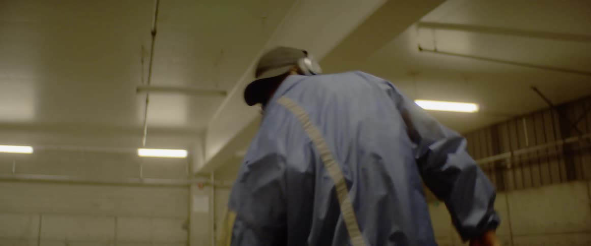 Man wearing headphones dances on underground parking lot