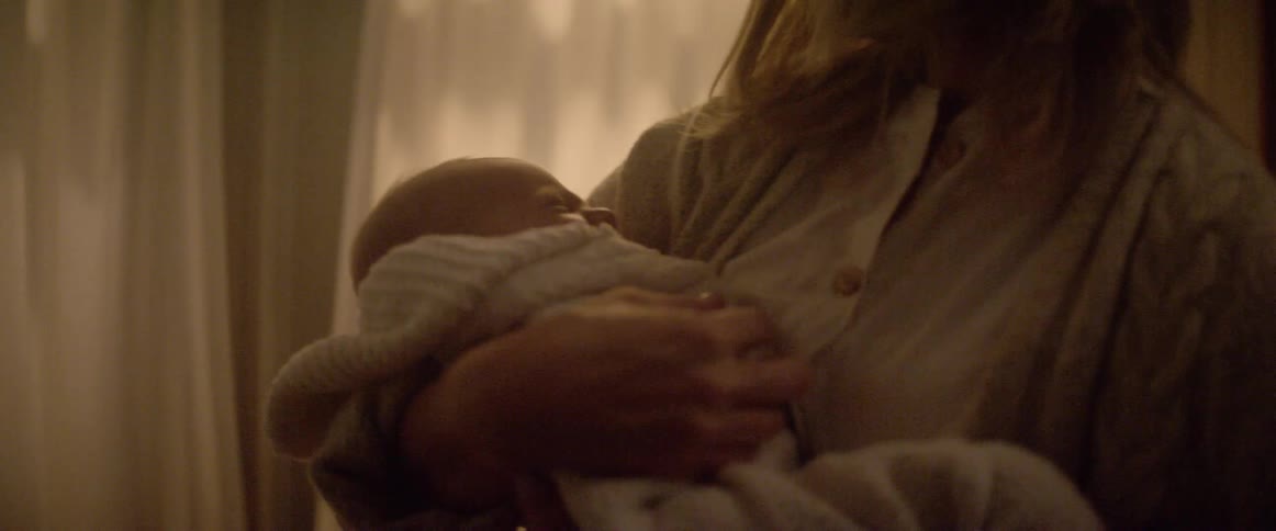 A woman picks up her baby