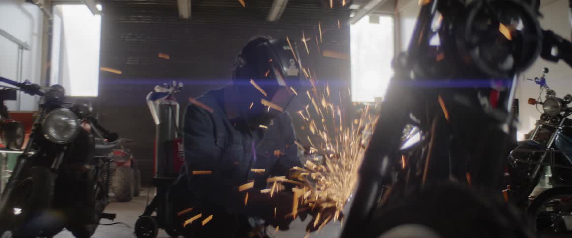 A mechanic works on a motorbike