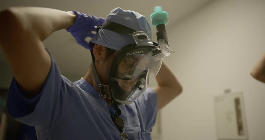 Doctor or nurse wearing protective face mask and gloves