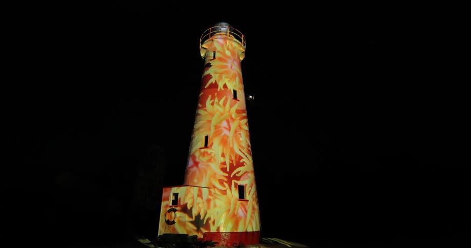 A lighthouse with flowers painted on it