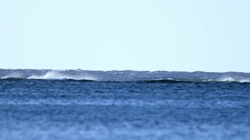 Waves are moving along an ocean