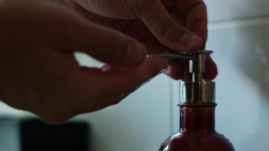 Person pumps soap in the bathroom