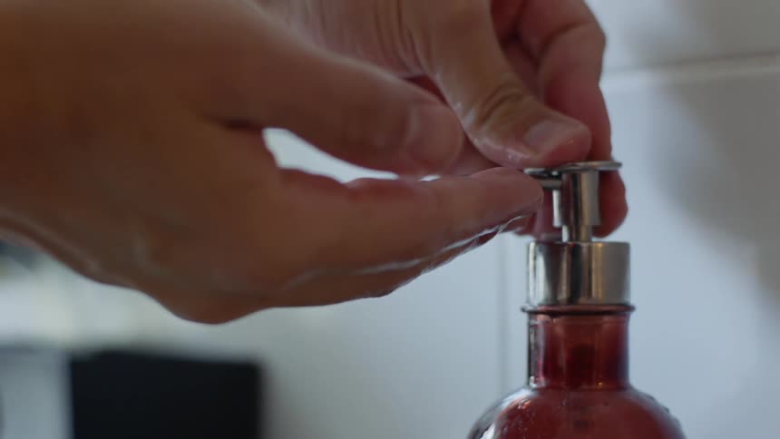 A man pumps soap in to his hands