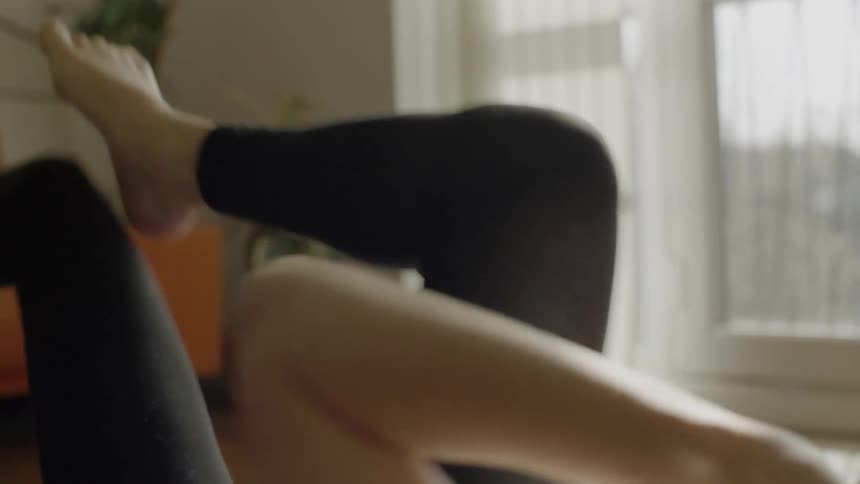 Female working out on the floor indoors at home