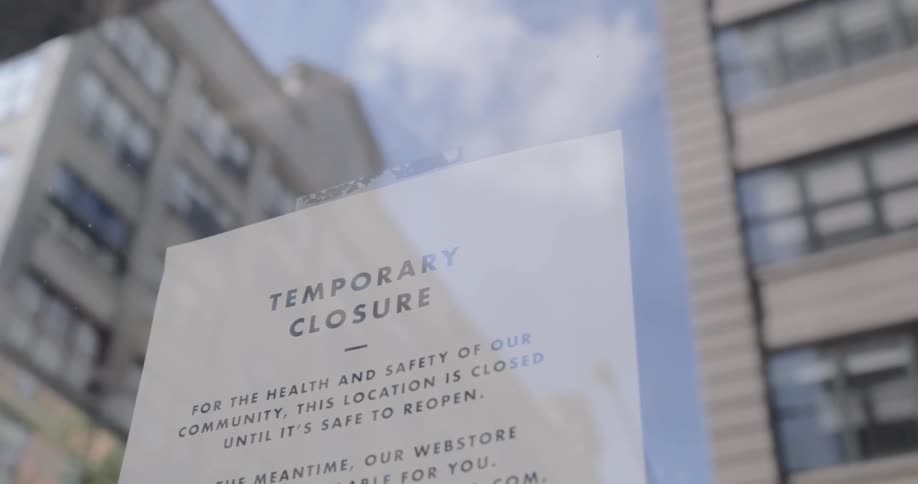 A notice hangs on a window of a business