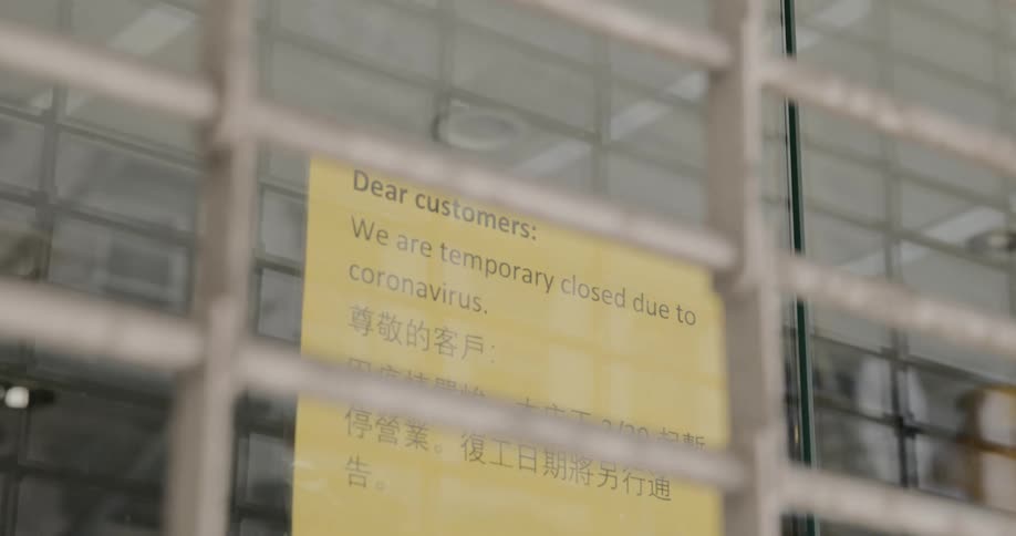 A close sign hangs in a store window