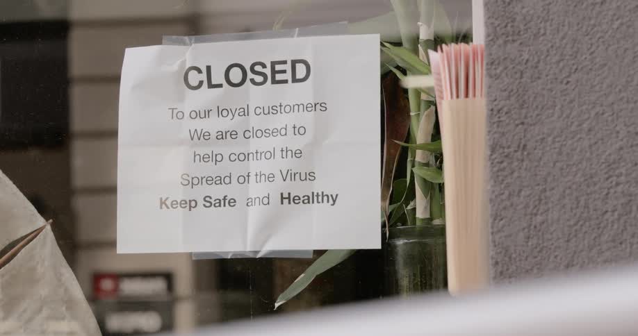 Closed sign on store window due to quarantine