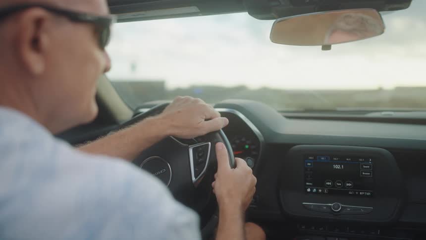 Man drives the vehicle to the beach on a cloudy day