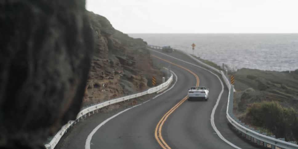Cars driving along the coast