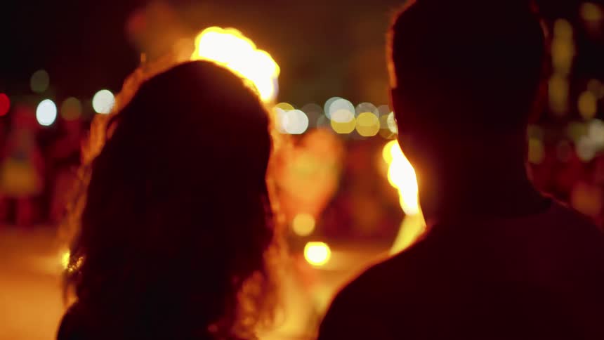 Couple enjoys outdoor night show on hawaii while vacationing