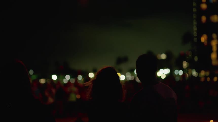 Couple enjoy beach night show while vacationing on hawaii