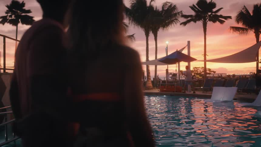 A couple walks to the pool