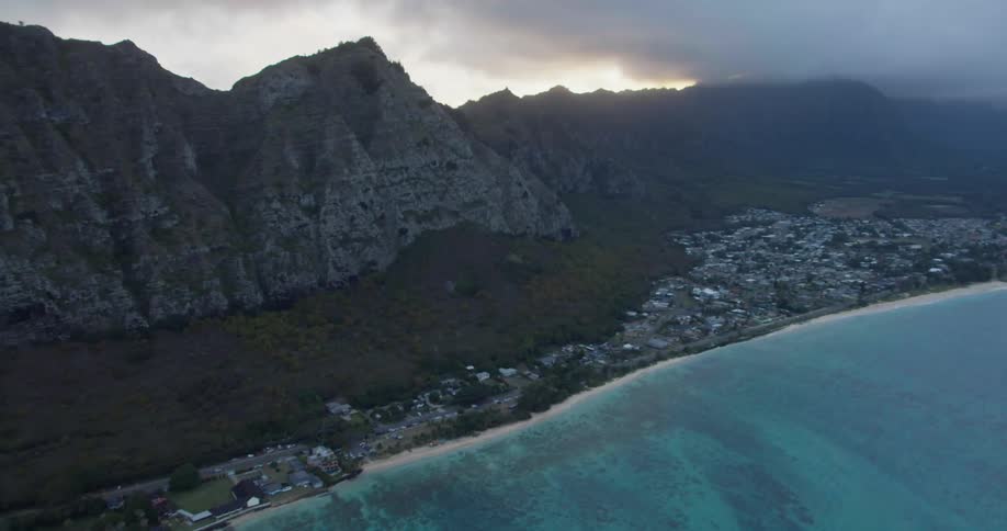 Aerial view of seaside town and mountain range at dawn