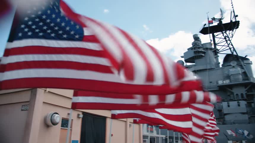 American flags flowing in the wind at a navy base