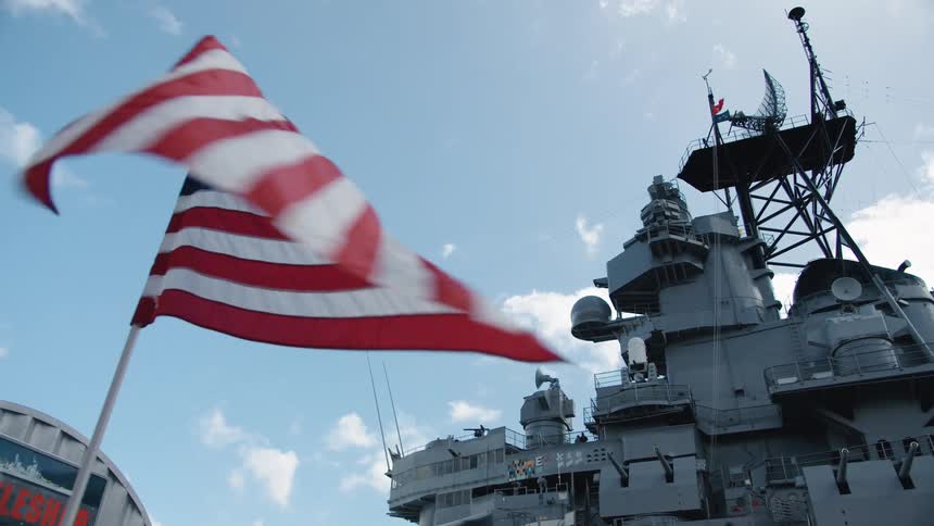 American flags fly near naval vessel