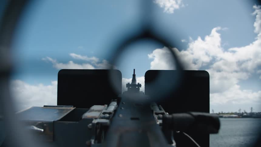 Siting through gun site toward opposite shore on cloudy day