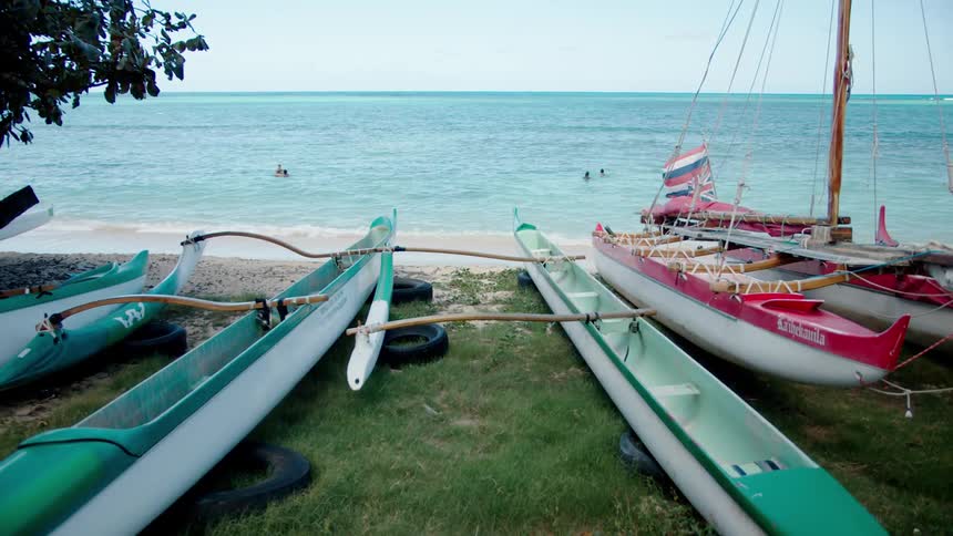 People are in the water with their boats on the shore line