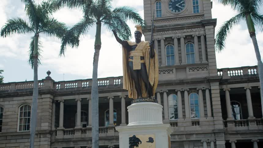 The sculpture stands in front of the building