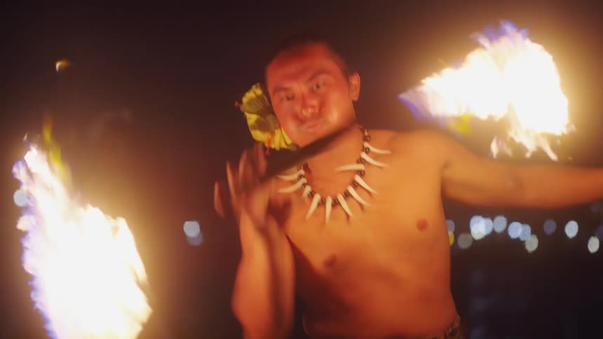 Hawaiian traditional fire dancer at night on beach