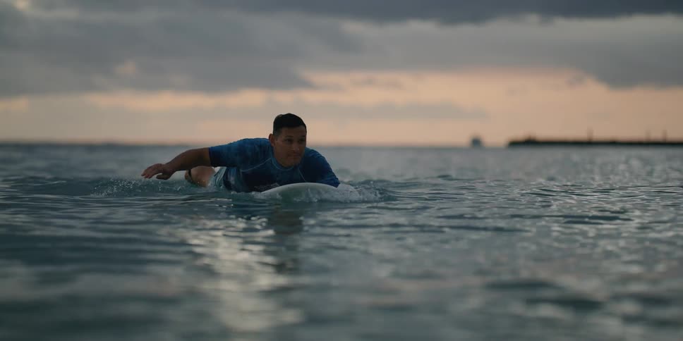 A man is on a surf board in the middle of the ocean