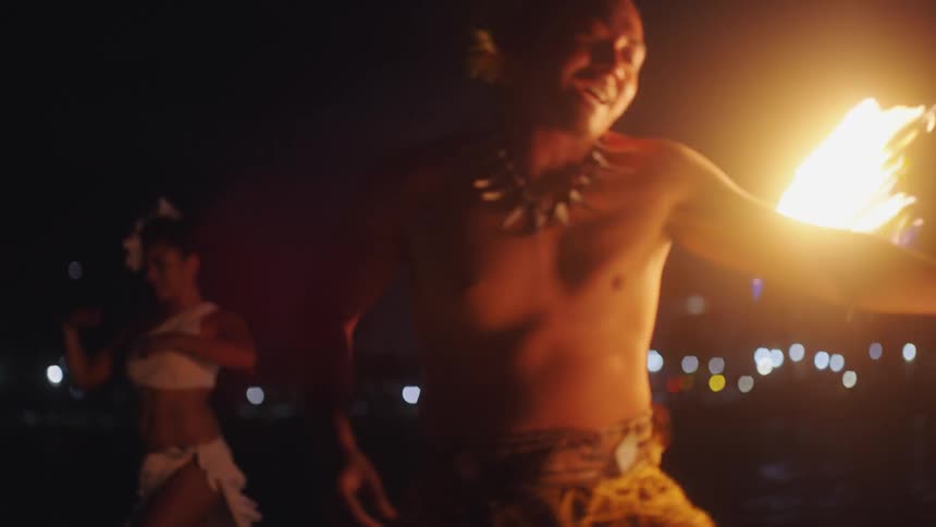 A man tosses flames around his body