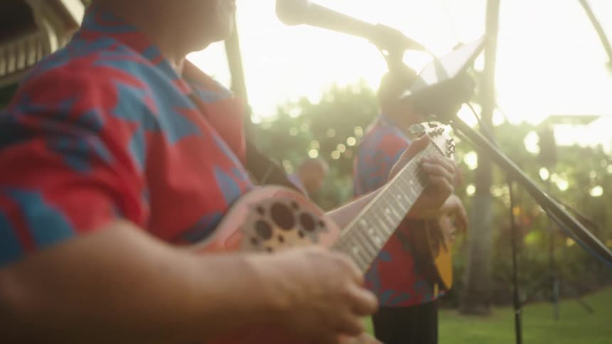 Two people play guitar and sing