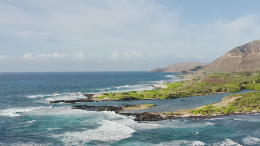 The rough waves crash against the island shore