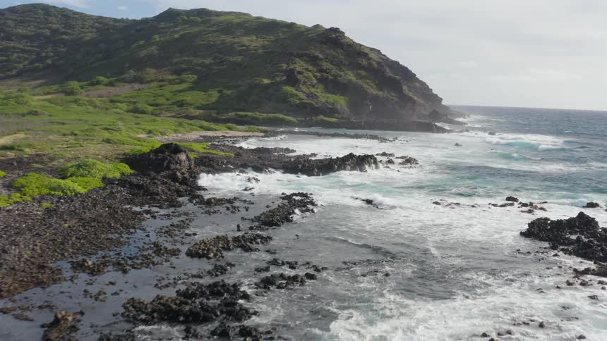 Aerial view of ocean waves crashing against the shore