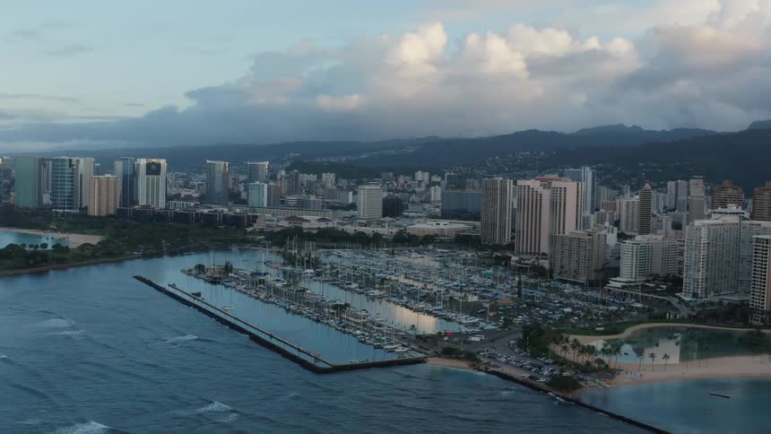 A city close to the coast with mountains and the sky in the background