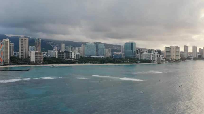 Aerial view of the city next to the ocean on a cloudy day