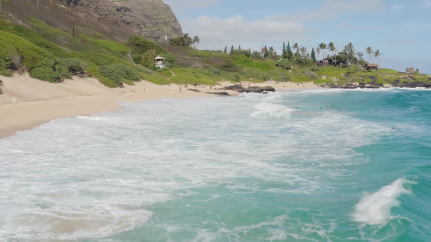 Waves crash on the shore of a beach