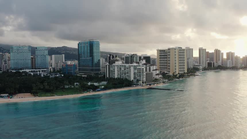 Skyline of the city with tall buildings and white sand beach next to the ocean