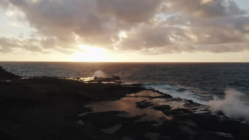 The rough waves crash against the shore