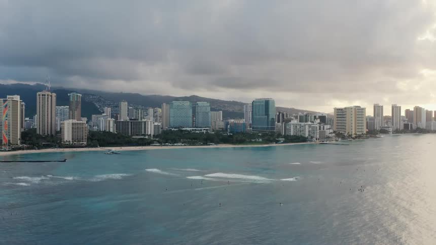 Aerial view of a city beachfront at sunset