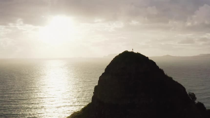 A person stands on the rock