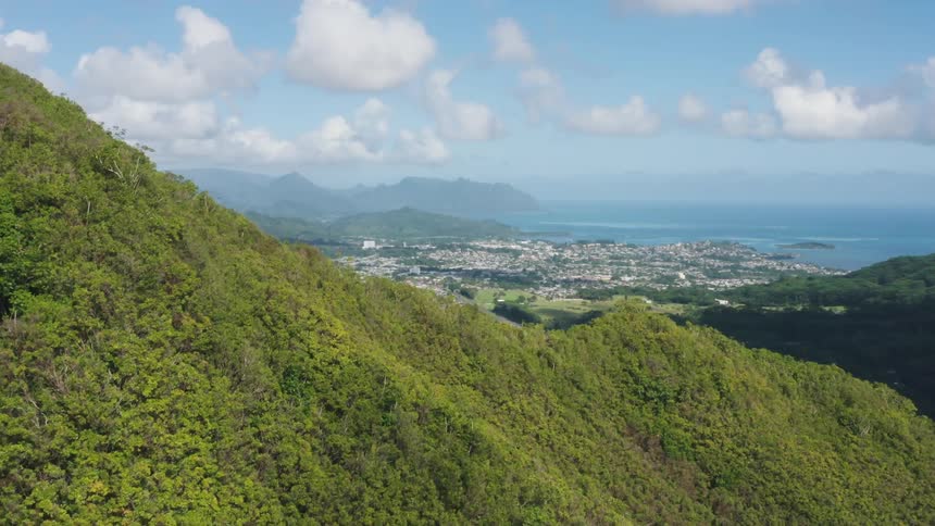 Mountains and valley with oceanside city in the distance