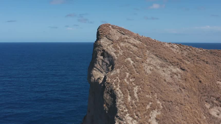 A cliff in the ocean is displayed