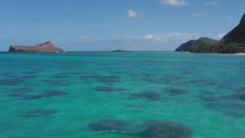 A small island lays in a tropical ocean