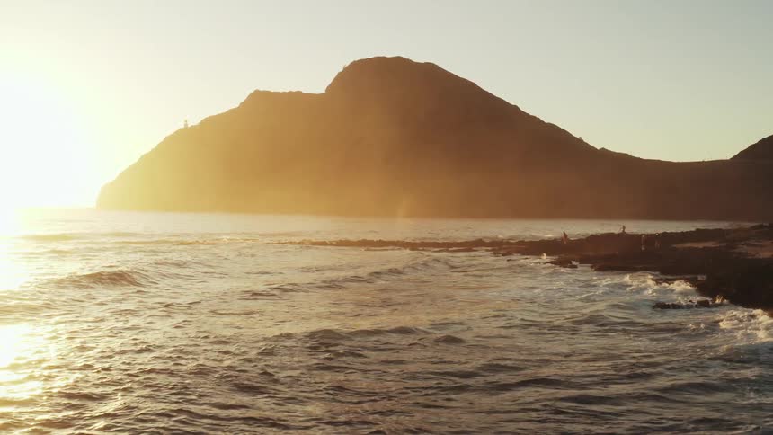 A promontory jutting out into the sea near a rocky beach
