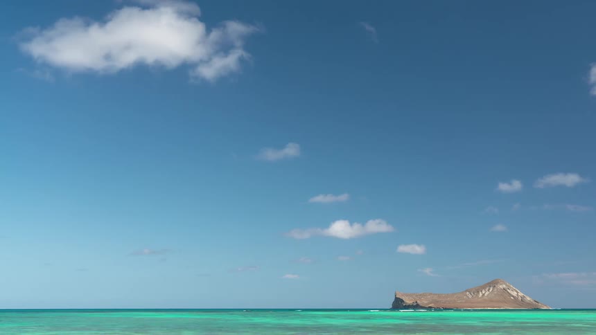 Time lapse of small island in tropical waters in daytime