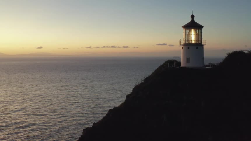 A lighthouse is near the body of water
