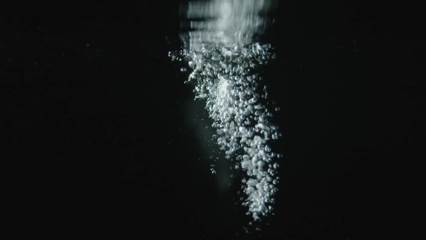 Water drips into the liquid and forms bubbles