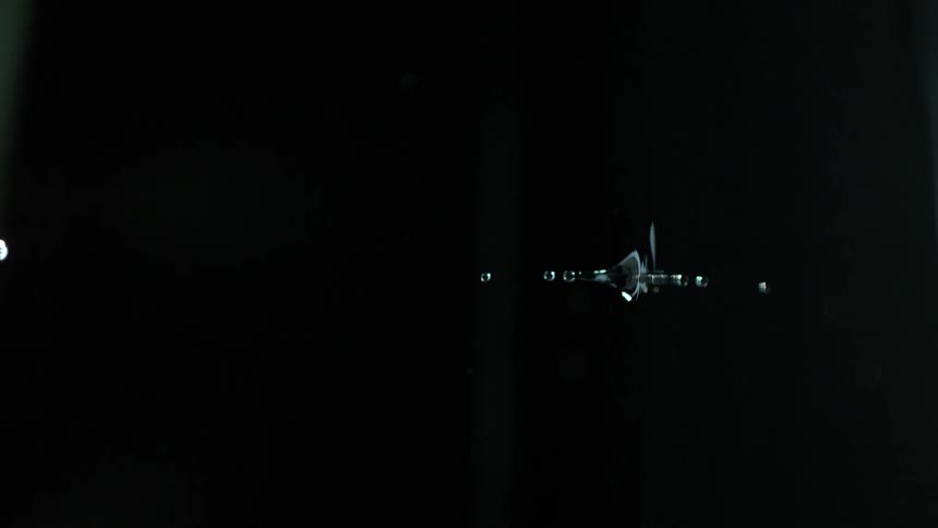 Slow motion reversed footage of water droplet