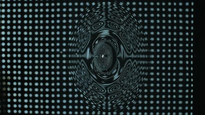 Liquid swirls and spreads over the white spots