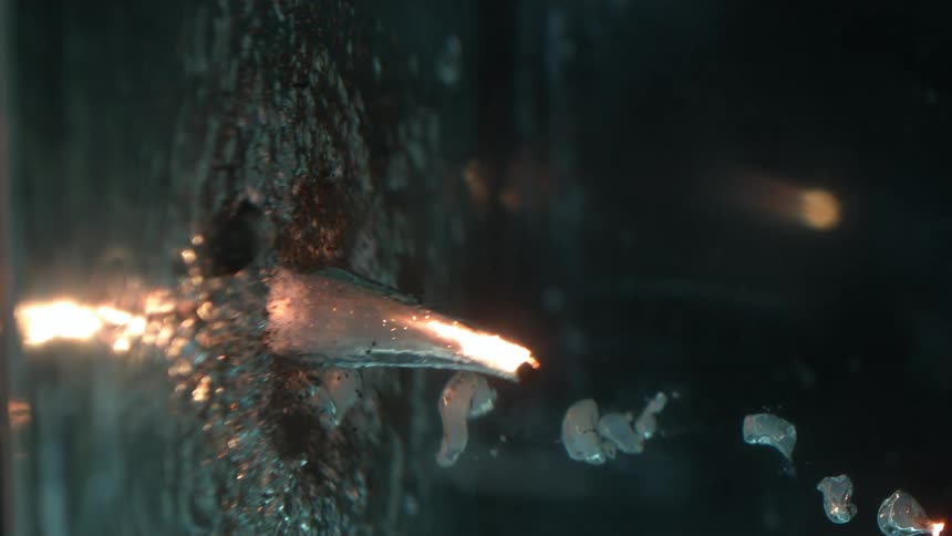 Ignited particles sinking in water in slow motion